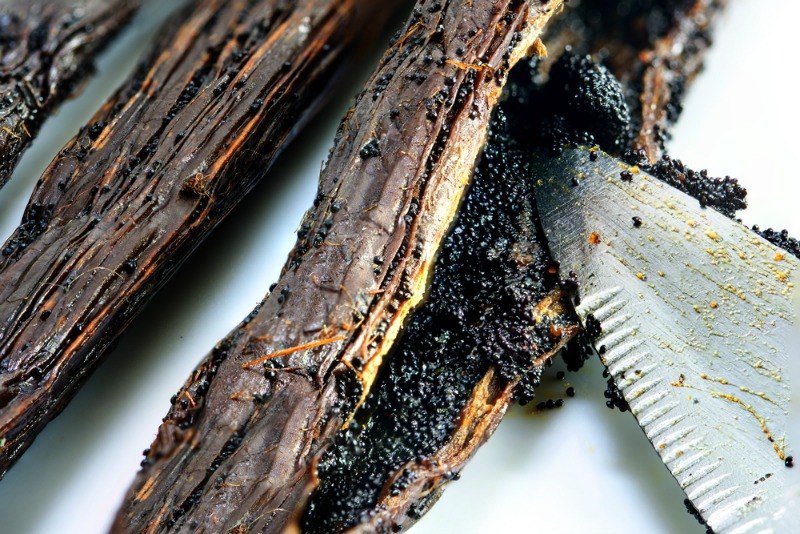A sliced open vanilla bean pod