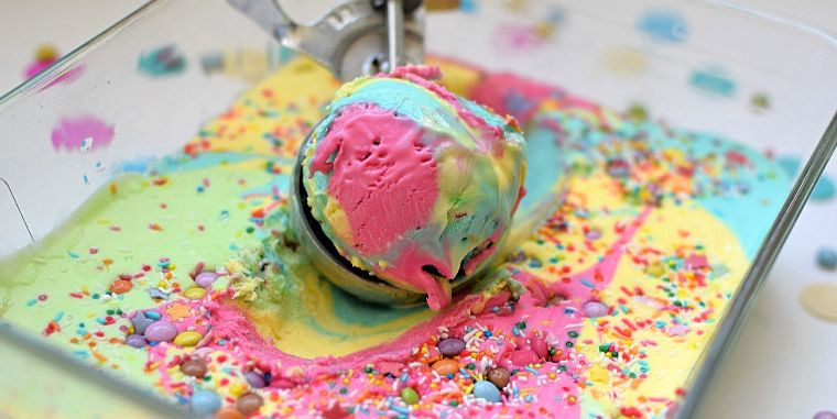 Scooped rainbow ice cream in a dish.