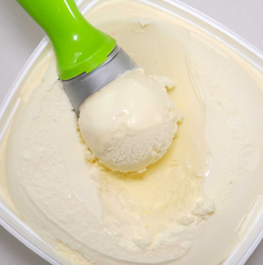 Bird's eye image of a scoop resting on the top of a pack of Coles ice cream.
