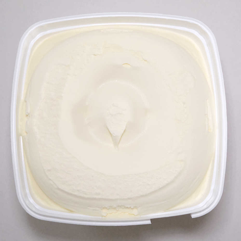 A unscooped pack of Coles Vanilla 2L.