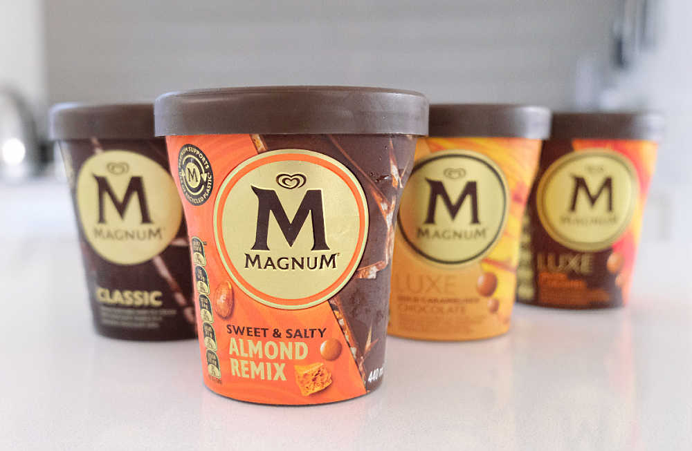 A row of Magnum Ice Cream tubs with Sweet and Salty Almond Remix at the front.