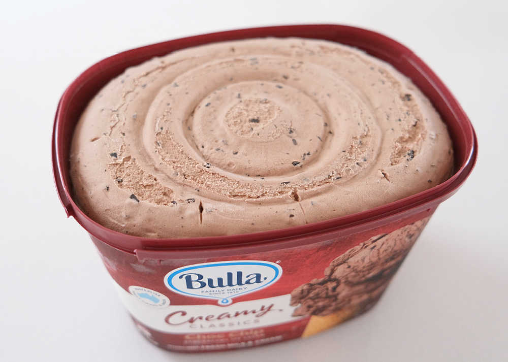 An unscooped container of chocolate chip ice cream 2L, Creamy Classics.
